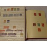 A folder album and stock book containing a collection of Australia stamps,