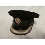 A green cloth Officers peaked cap of the Duke of Cornwall's Light Infantry with silver plated cap