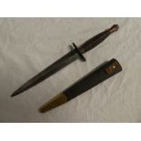 A Commando dagger by W Rodgers of Sheffield with blackened double edged blade and coppered hilt in