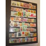 A stock book containing mainly GB used commemorative stamps and Foreign stamps,