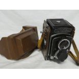 A Minolta autocord twin lens reflex camera in leather carrying case