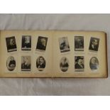 An Ogden's album containing a set of Guinea Gold cigarette cards nos 1-200 including various