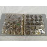 An album containing a collection of Foreign coins including numerous silver examples,