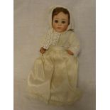 A small German porcelain headed doll "HG Dep" with composition jointed body 7½" long