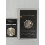 An American 1922 un-circulated peace silver dollar and 1972 Eisenhower proof dollar (2)
