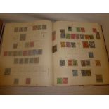 A boxed folder album containing a collection of British Commonwealth stamps