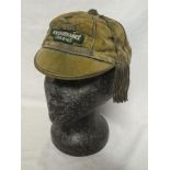 A green velvet College Rugby cap with applied cloth badge "R.N.