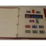 A folder album containing a collection of GB stamps,