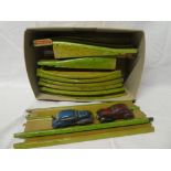 An English tin plate green & yellow Raceway with fly over sections and two small clockwork cars