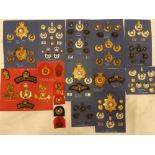 A collection of Royal Marines badges and insignia including three silver-gilt Queen's crown