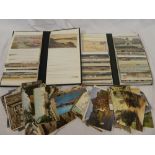 Two albums containing a selection of mixed black & white and coloured postcards including some