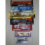 A selection of mint & boxed die-cast commercial vehicles including Cat Peterbilt low loader with