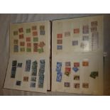 Two small stock books containing a selection of GB over-print stamps,