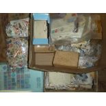 A box containing various World stamps in bags, boxes, stock cards,
