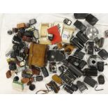 A large selection of various camera accessories including numerous lenses, telephoto lenses,