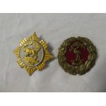 A brass Licensed Victualler's badge and one other similar silver gilt badge (2)