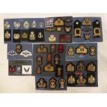 A collection of Royal Navy badges and insignia including Officers cap badges,