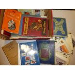 A box containing various albums of World stamps, catalogues, PHQ cards,