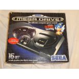 A Sega Megadrive 16-bit games console with two hand sets,