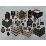 A collection of Grenadier Guards badges and insignia including Officers embroidered wire cap badge