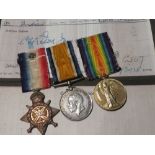 A 1914 star trio of medals with rosette awarded No.25869 Dvr. A.
