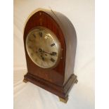 A good quality German bracket clock with silvered circular dial in inlaid mahogany Gothic arched
