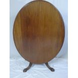 A Victorian mahogany oval turn-over top breakfast table on turned column with scroll legs