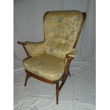 A 1960's Ercol light elm easy chair upholstered in floral art silk