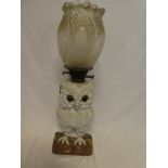 A Continental china oil lamp in the form of an owl with brass mounts and scroll decorated shade,