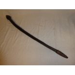 An old African carved wood club with bulbous end,