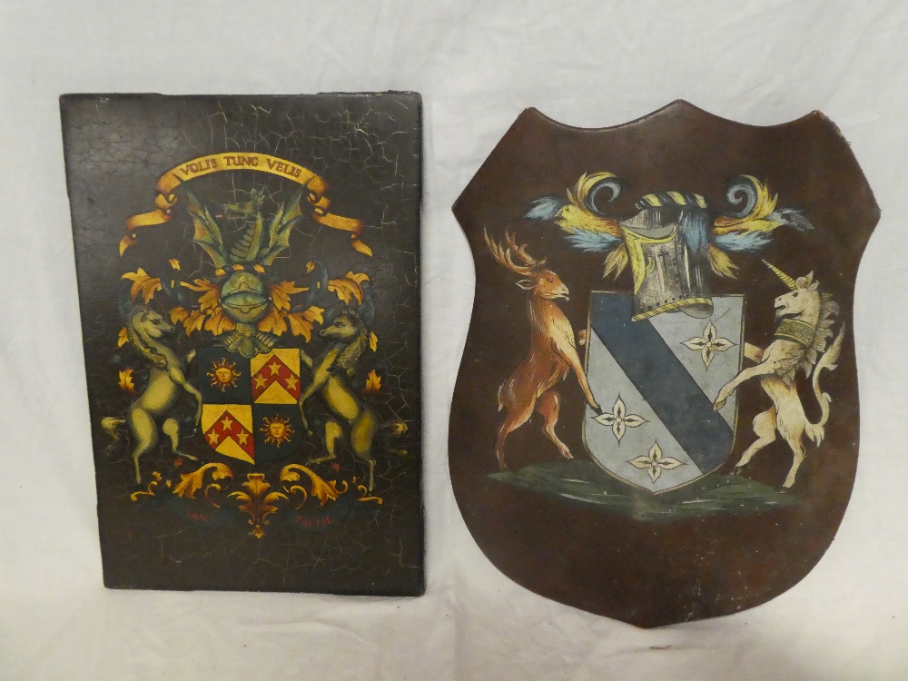 A painted wooden armorial shield,