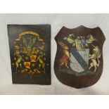 A painted wooden armorial shield,