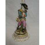 A German porcelain candlestick in the form of a young boy with rabbit on circular base 11" high