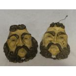 A pair of unusual old carved and painted wood wall brackets in the form of grotesque faces