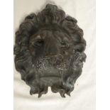 An old bronze lions mask plaque marked "C8644",