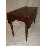 A Victorian polished mahogany rectangular drop leaf Pembroke table with drawer in one end on turned