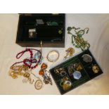 A leather jewellery box containing a quantity of various costume jewellery