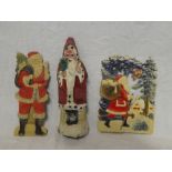 A small selection of vintage Christmas decorations including pressed card Father Christmas dated