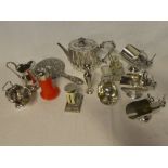 A selection of various silver-plated items including oval tea pot, cruet, sugar helmets,