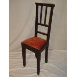 An unusual late 19th Century child's chair with rail back and upholstered seat on square legs