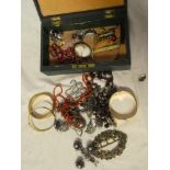 A jewellery box containing a quantity of various costume jewellery