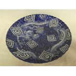 A 19th Century Japanese pottery circular charger with blue and white dragon and floral decoration,