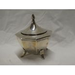 An Edward VII silver octagonal condiment jar and cover on tapered legs,