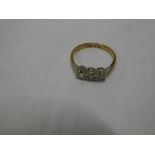 An 18ct gold dress ring with platinum shoulders set three small diamonds