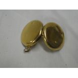 An 18ct gold circular pendant locket