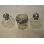 A pair of late Victorian cut glass square tapered scent bottles with silver mounted tops,