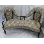 A mid-Victorian rosewood curved double scroll end settee with barley twist supports upholstered in