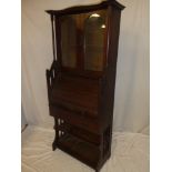 An Edwardian oak roll-top bureau bookcase with pigeon holes enclosed by a tambour front above a