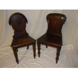 Two Victorian mahogany hall chairs with polished shaped backs and plain seats on turned tapered