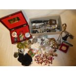 A jewellery box containing various costume jewellery together with plated cutlery,